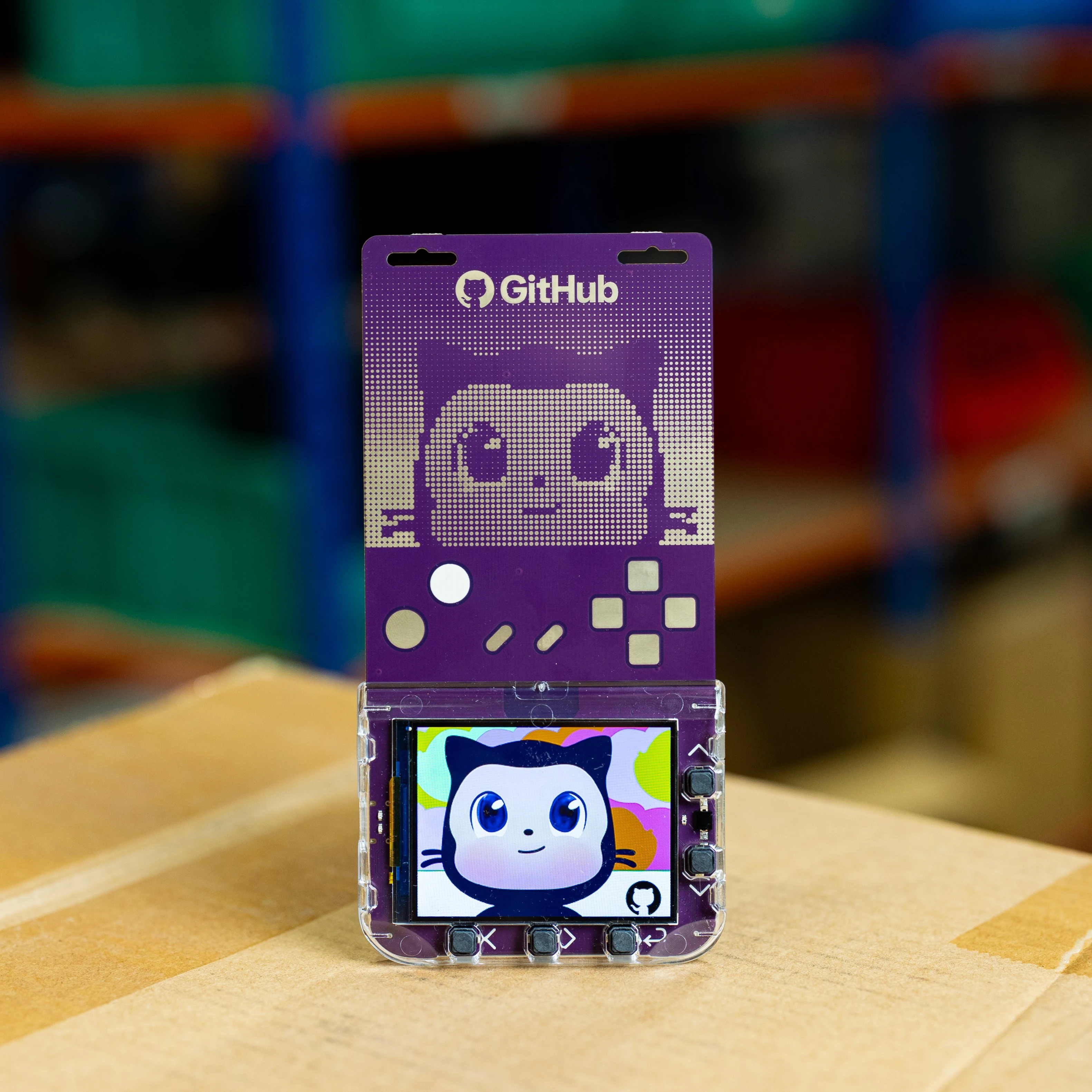 GitHub Universe 2026 programmable badge. It is purple, has gaming controller motifs, and an image of Mona.